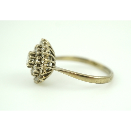 317 - A diamond ring, of cluster design, set with a brilliant-cut diamond within two concentric bands of s... 