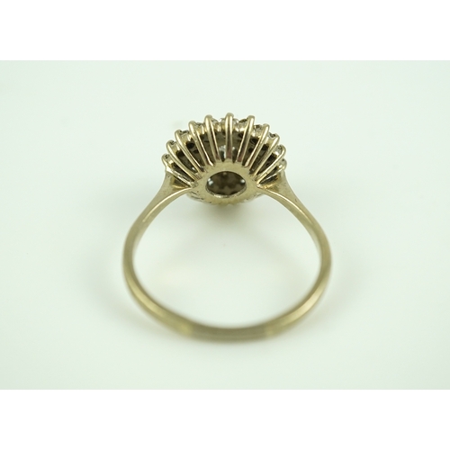 317 - A diamond ring, of cluster design, set with a brilliant-cut diamond within two concentric bands of s... 