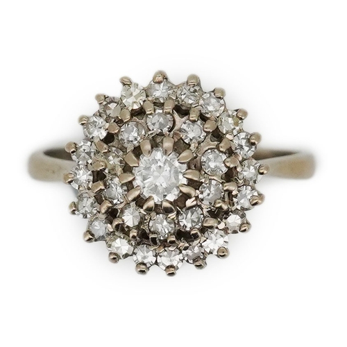 317 - A diamond ring, of cluster design, set with a brilliant-cut diamond within two concentric bands of s... 