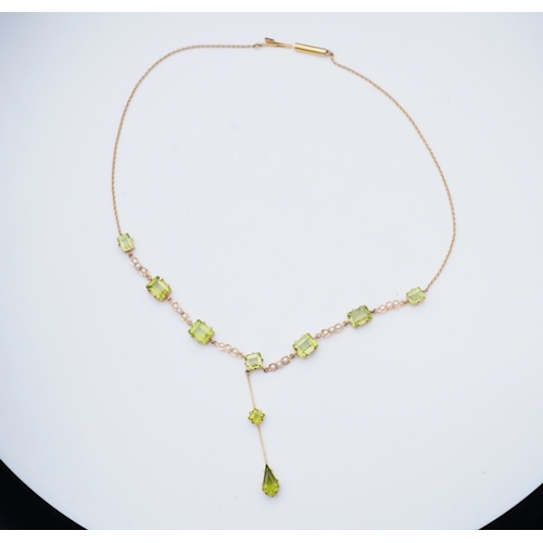 320 - An Edwardian peridot and seed pearl necklace, early 20th century the front composed of links claw-se... 