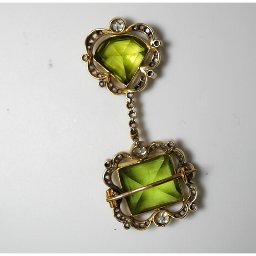 321 - A peridot and diamond brooch, circa 1900 Composed of a step-cut peridot within a foliate border of c... 