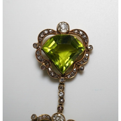 321 - A peridot and diamond brooch, circa 1900 Composed of a step-cut peridot within a foliate border of c... 