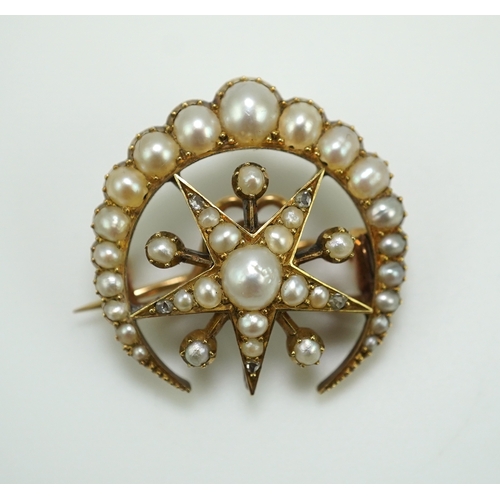 322 - An Edwardian half pearl and diamond brooch, early 20th century, designed as a crescent moon enclosin... 