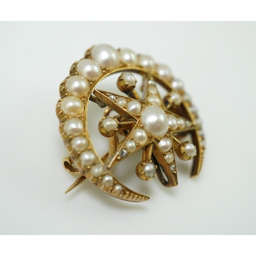 322 - An Edwardian half pearl and diamond brooch, early 20th century, designed as a crescent moon enclosin... 