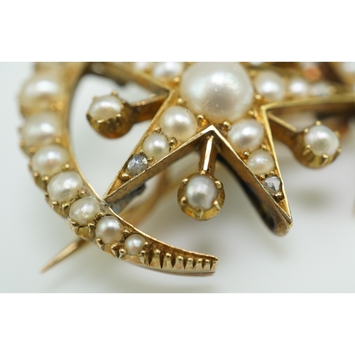 322 - An Edwardian half pearl and diamond brooch, early 20th century, designed as a crescent moon enclosin... 