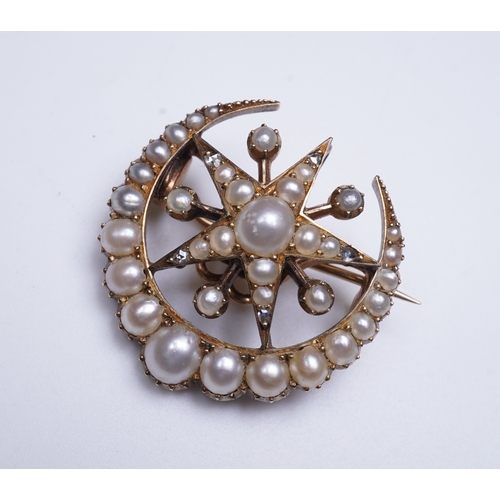 322 - An Edwardian half pearl and diamond brooch, early 20th century, designed as a crescent moon enclosin... 