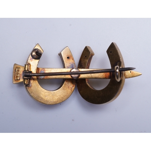 324 - A Victorian gold and seed pearl brooch, mid 19th century designed as a pair of horseshoes joined by ... 