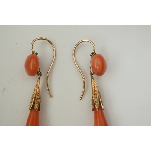 329 - Y Y A pair of coral earrings, mid 19th century, each composed of a coral cabochon suspending a coral... 