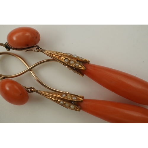 329 - Y Y A pair of coral earrings, mid 19th century, each composed of a coral cabochon suspending a coral... 