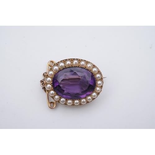 330 - An amethyst and split pearl brooch, circa 1900, of oval outline, set with an oval amethyst within a ... 