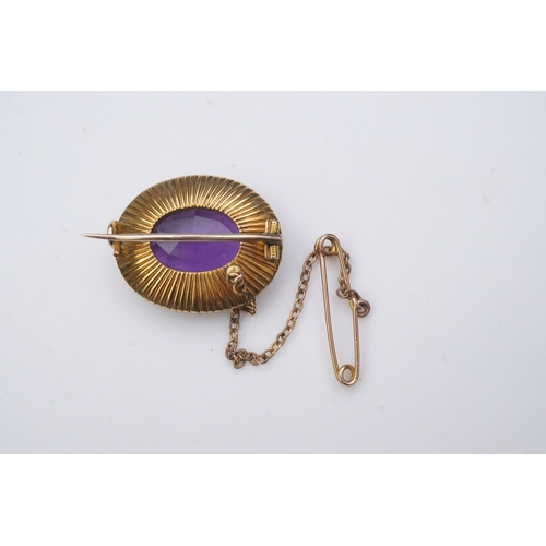 330 - An amethyst and split pearl brooch, circa 1900, of oval outline, set with an oval amethyst within a ... 