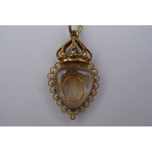 332 - An unusual gold pendant, late 18th/early 19th century, designed as a heart-shaped glazed compartment... 