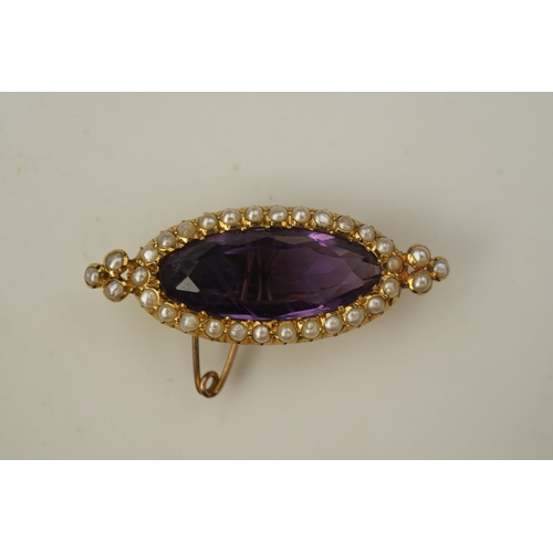 333 - An amethyst and pearl brooch, circa 1900, set with an elongated oval amethyst, bordered with half pe... 