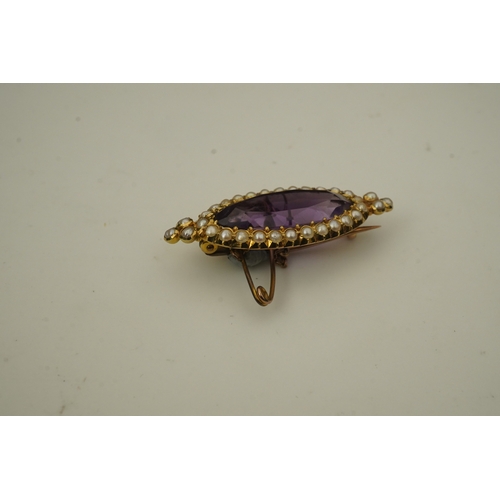 333 - An amethyst and pearl brooch, circa 1900, set with an elongated oval amethyst, bordered with half pe... 