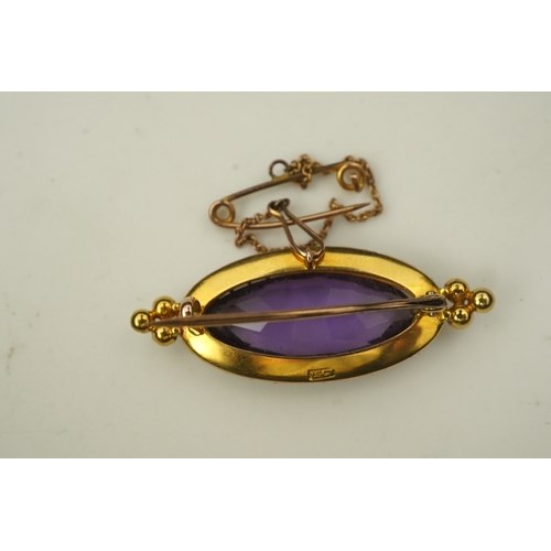 333 - An amethyst and pearl brooch, circa 1900, set with an elongated oval amethyst, bordered with half pe... 