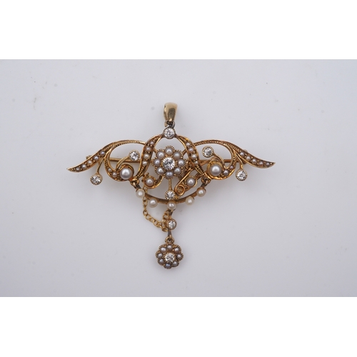 334 - An Edwardian seed pearl and diamond brooch, early 20th century, of foliate design, suspending a fest... 