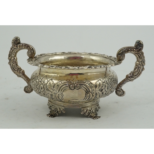 34 - A George IV Irish embossed silver two handled sugar bowl, by James Scott, with scroll handles and de... 