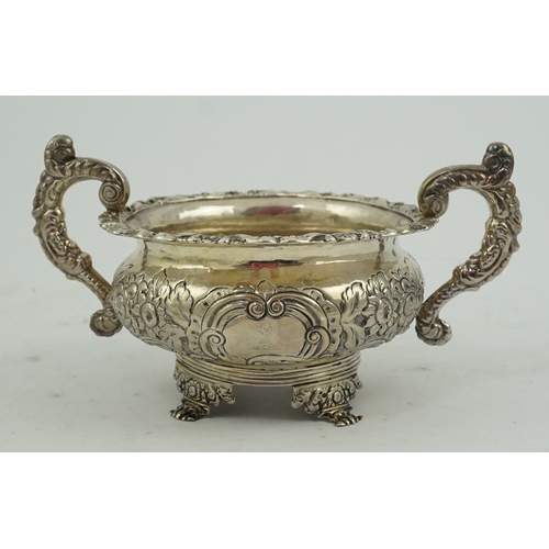 34 - A George IV Irish embossed silver two handled sugar bowl, by James Scott, with scroll handles and de... 