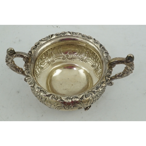 34 - A George IV Irish embossed silver two handled sugar bowl, by James Scott, with scroll handles and de... 