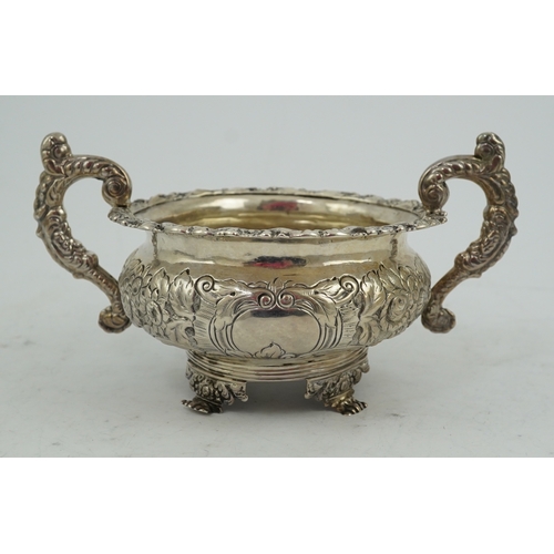 34 - A George IV Irish embossed silver two handled sugar bowl, by James Scott, with scroll handles and de... 