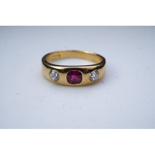 341 - A ruby and diamond three-stone ring, early 20th century, rubover-set with a cushion-shaped ruby betw... 