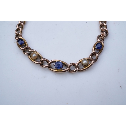 342 - A late Victorian sapphire and pearl bracelet, circa 1900, composed of curb linking, the central link... 