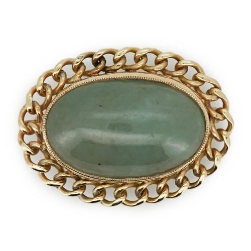 343 - A 9ct gold and jadeite brooch, set with a cabochon jadeite, within a curb link outer border in 9ct g... 