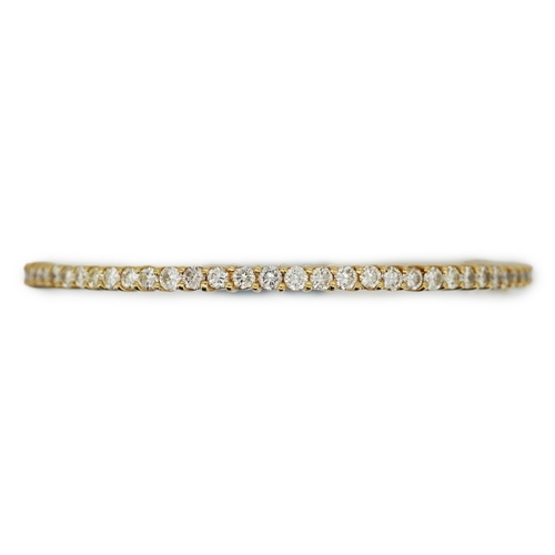 345 - A diamond bangle, of hinged design, set throughout with brilliant-cut diamonds totalling approximate... 