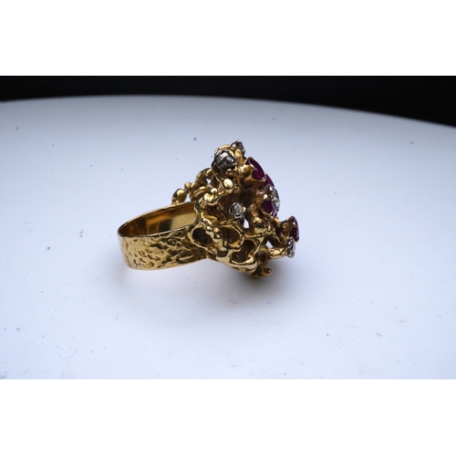 349 - A ruby and diamond cocktail ring, 1970s, of abstract textured design, set with circular-cut diamonds... 