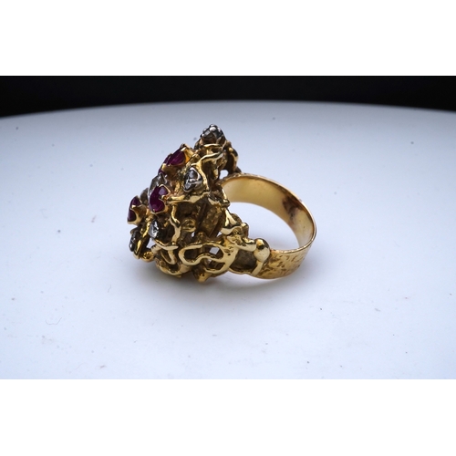 349 - A ruby and diamond cocktail ring, 1970s, of abstract textured design, set with circular-cut diamonds... 