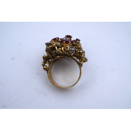 349 - A ruby and diamond cocktail ring, 1970s, of abstract textured design, set with circular-cut diamonds... 