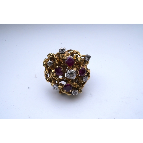 349 - A ruby and diamond cocktail ring, 1970s, of abstract textured design, set with circular-cut diamonds... 