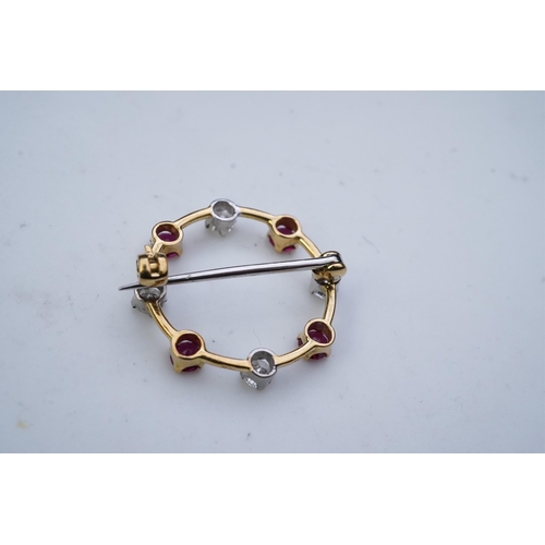 350 - A ruby and diamond brooch, designed as a ring of alternating circular-cut rubies and brilliant-cut d... 