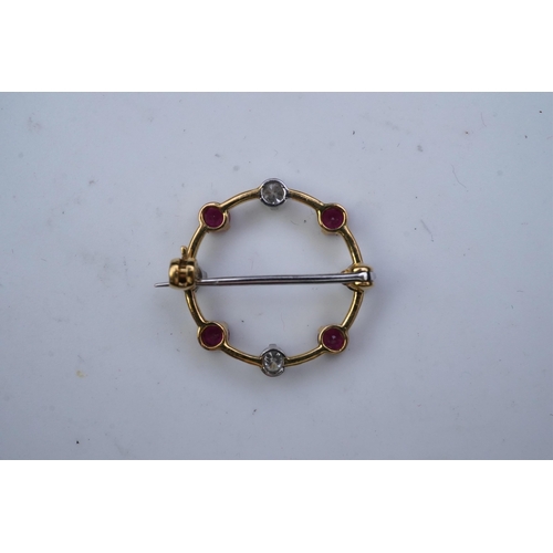 350 - A ruby and diamond brooch, designed as a ring of alternating circular-cut rubies and brilliant-cut d... 