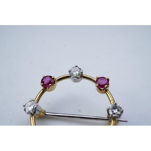 350 - A ruby and diamond brooch, designed as a ring of alternating circular-cut rubies and brilliant-cut d... 