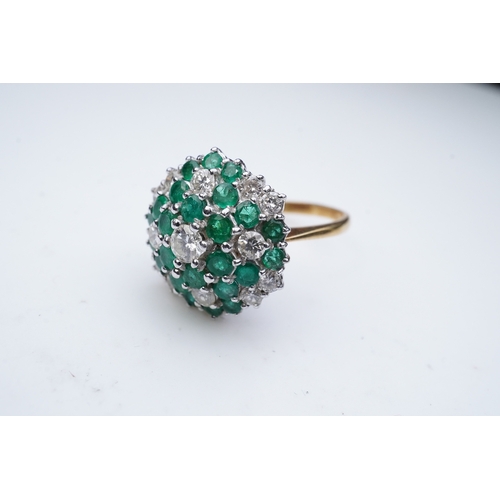 351 - An emerald and diamond cocktail ring, of bombé cluster design, set with brilliant-cut diamonds and c... 