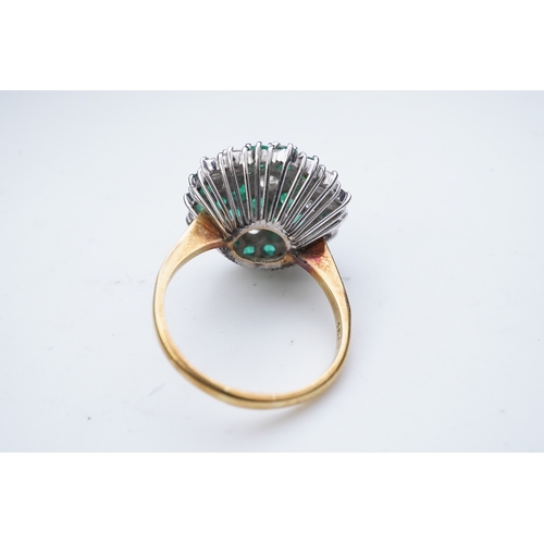 351 - An emerald and diamond cocktail ring, of bombé cluster design, set with brilliant-cut diamonds and c... 