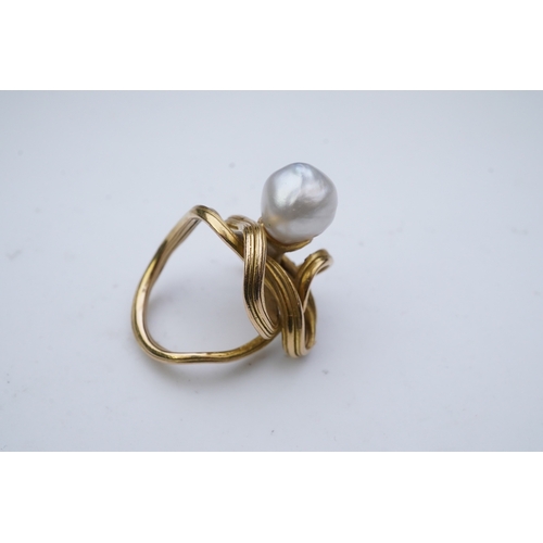 352 - A pearl ring, in the Art Nouveau style, designed as a sinuous tendril, set with a pearl measuring ap... 