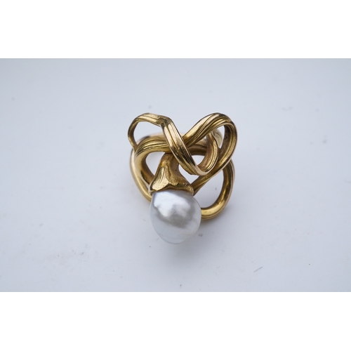 352 - A pearl ring, in the Art Nouveau style, designed as a sinuous tendril, set with a pearl measuring ap... 