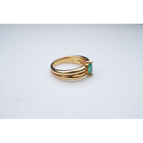 353 - An emerald and diamond ring, set with a marquise-shaped emerald, to a double band set with brilliant... 