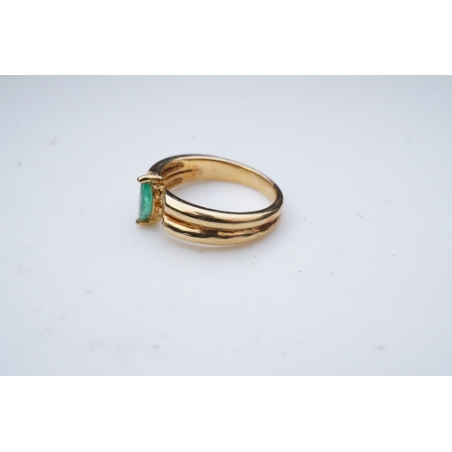 353 - An emerald and diamond ring, set with a marquise-shaped emerald, to a double band set with brilliant... 