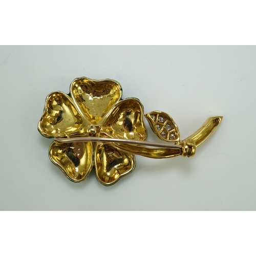 359 - An enamel and diamond brooch, designed as a flower, its petals applied with green enamel in a grid p... 