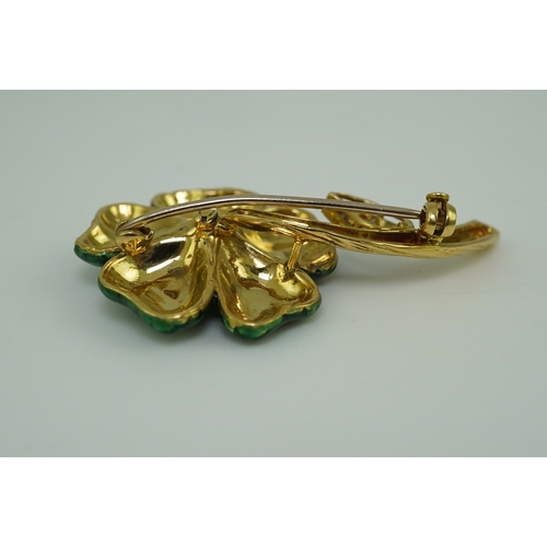 359 - An enamel and diamond brooch, designed as a flower, its petals applied with green enamel in a grid p... 