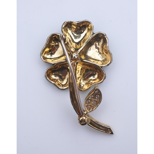 359 - An enamel and diamond brooch, designed as a flower, its petals applied with green enamel in a grid p... 