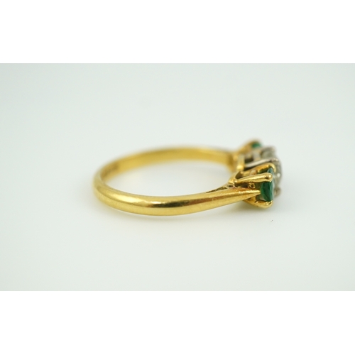 360 - An emerald and diamond three-stone ring, claw-set with a circular-cut diamond weighing approximately... 