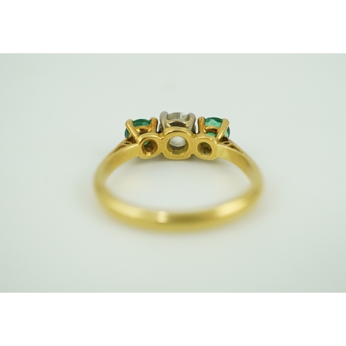 360 - An emerald and diamond three-stone ring, claw-set with a circular-cut diamond weighing approximately... 