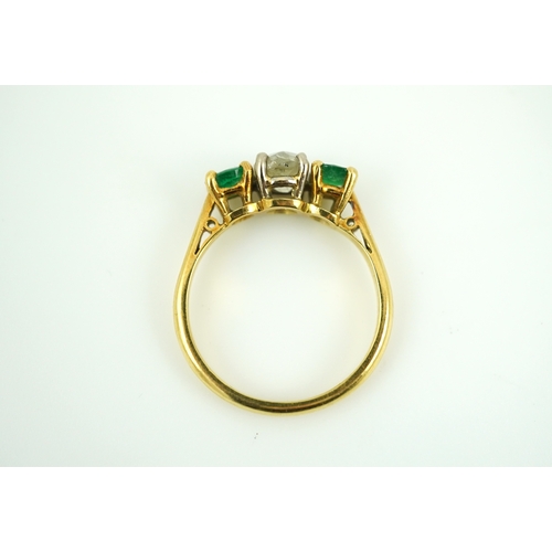 360 - An emerald and diamond three-stone ring, claw-set with a circular-cut diamond weighing approximately... 