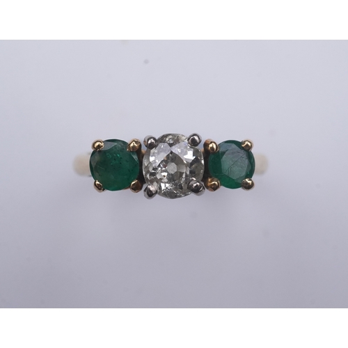 360 - An emerald and diamond three-stone ring, claw-set with a circular-cut diamond weighing approximately... 