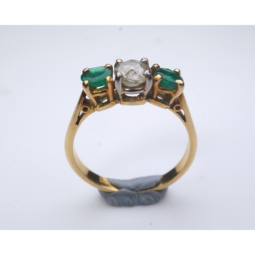 360 - An emerald and diamond three-stone ring, claw-set with a circular-cut diamond weighing approximately... 