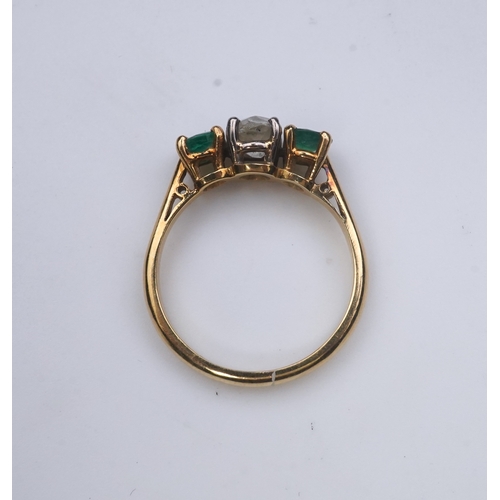 360 - An emerald and diamond three-stone ring, claw-set with a circular-cut diamond weighing approximately... 